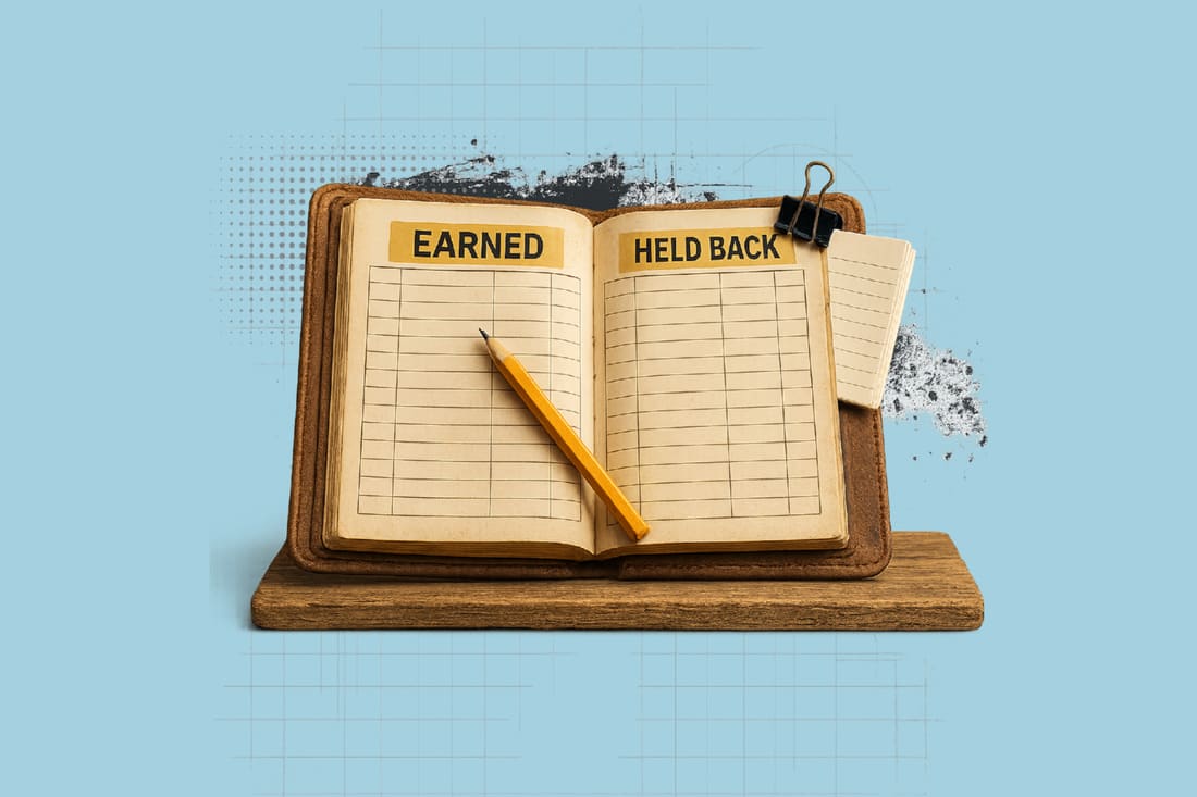 Open ledger book with 'Earned' and 'Held Back' columns, a pencil resting across the pages, displayed on a wooden stand.