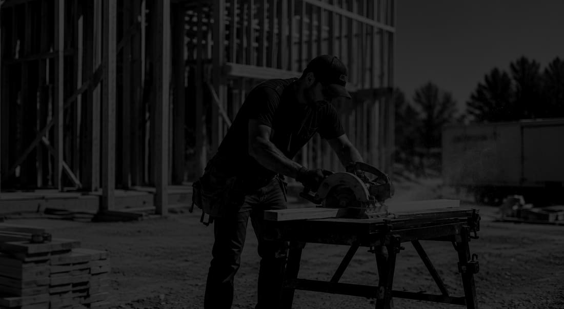 Man cutting a board with a circular saw on a folding work table